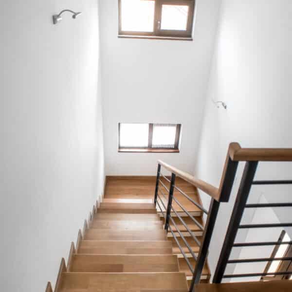 Living room stairs, modern minimalist interior design  Wooden staircase with metallic elements at private mansion