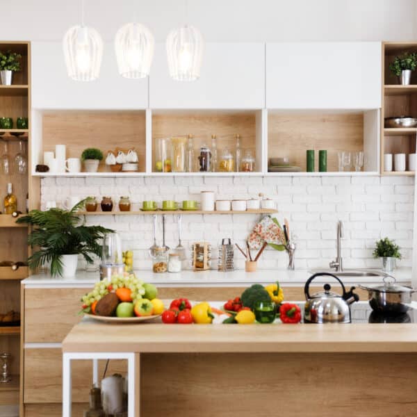 Wooden kitchen interior with island and big table